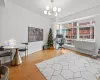 Home office with hardwood / wood-style flooring and a chandelier