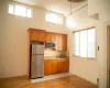 Kitchen featuring backsplash, stainless steel appliances, sink, a high ceiling, and hanging light fixtures