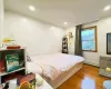 Bedroom featuring a baseboard radiator and light wood-type flooring