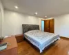 Bedroom with dark wood-type flooring