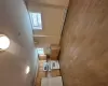 Kitchen featuring a baseboard radiator, light hardwood / wood-style flooring, fridge, light brown cabinetry, and range