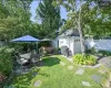 View of yard with an outdoor structure, a hot tub, and a garage