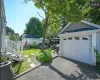 Garage featuring a lawn