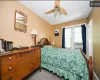 Bedroom featuring ceiling fan and cooling unit