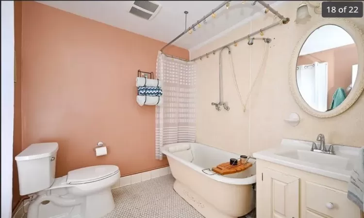 Bathroom featuring tile patterned floors, vanity, and toilet