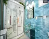 Bathroom with tile patterned floors, vanity, and an enclosed shower