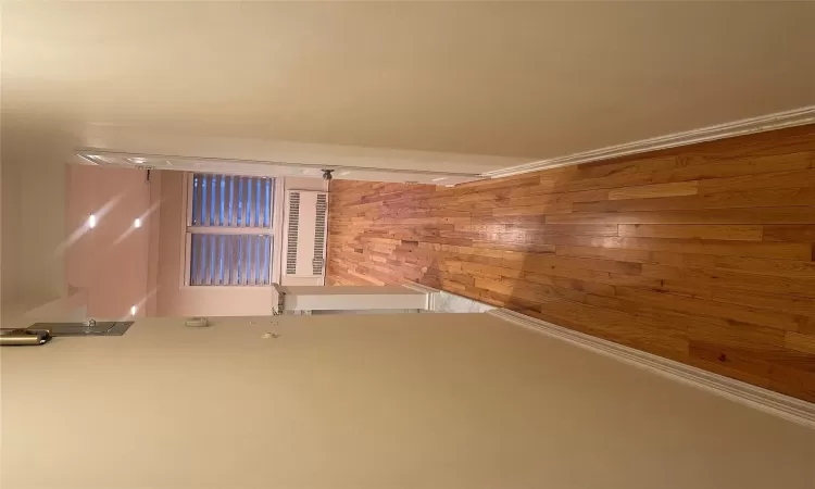 Corridor with radiator and light hardwood / wood-style flooring