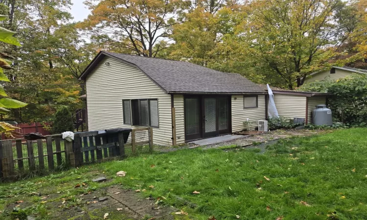 Rear view of house featuring a yard