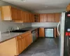 Kitchen with dark stone countertops, sink, and stainless steel appliances