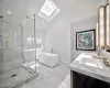 Bathroom with plus walk in shower, vanity, and lofted ceiling with skylight