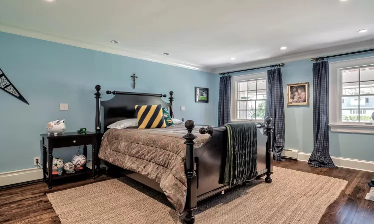 Bedroom with crown molding and custom closet