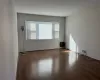 Unfurnished room with dark wood-type flooring