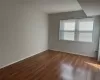 Unfurnished room with dark wood-type flooring