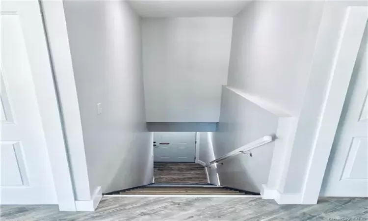 Stairs with hardwood / wood-style flooring