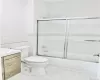 Full bathroom with shower / bath combination with glass door, tile patterned floors, vanity, and toilet