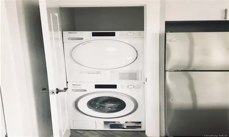 Clothes washing area with stacked washer / dryer