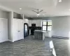 Kitchen featuring a kitchen island, white cabinets, a baseboard heating unit, and appliances with stainless steel finishes