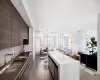 Kitchen featuring sink, a center island, stainless steel gas cooktop, tasteful backsplash, and expansive windows