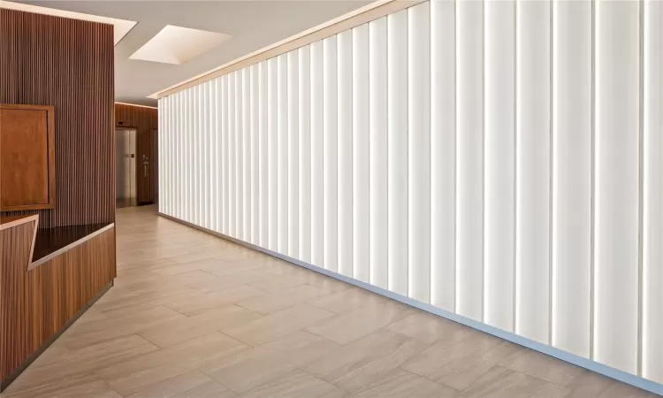 Hallway featuring wooden walls