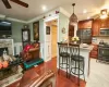 Kitchen featuring pendant lighting, a kitchen breakfast bar, crown molding, ceiling fan, and stainless steel appliances