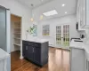 Kitchen featuring a skylight, pendant lighting, dark hardwood floors