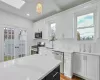 Kitchen featuring appliances with stainless steel finishes, tasteful backsplash, sink, decorative light fixtures, and white cabinets