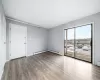 Spare room featuring baseboard heating and light hardwood / wood-style flooring