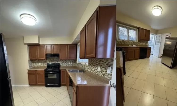 Kitchen featuring black appliances, decorative backsplash, and sink