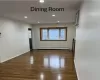 Unfurnished room featuring dark hardwood / wood-style floors and a baseboard heating unit