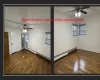 Spare room featuring ceiling fan, dark hardwood / wood-style flooring, and a baseboard radiator