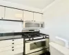 Kitchen featuring stainless steel appliances and white cabinetry