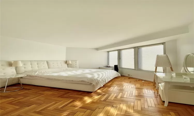 Bedroom featuring light parquet flooring