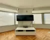 Bedroom featuring multiple windows and light parquet floors