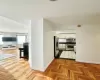 Kitchen featuring white cabinetry, stainless steel appliances, and light parquet floors