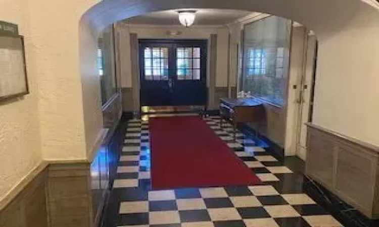 Foyer entrance with french doors and ornamental molding