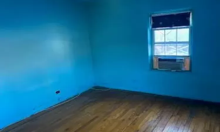 Spare room featuring dark hardwood / wood-style flooring and cooling unit