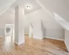 Bonus room featuring light hardwood / wood-style floors and lofted ceiling