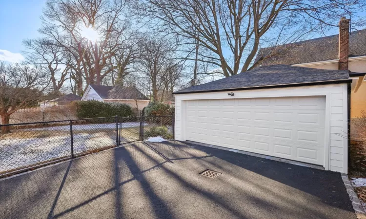 Back of property with central AC and a sunroom