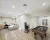 Laundry area with washer and dryer and light hardwood / wood-style flooring