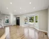 Foyer featuring light wood-type flooring, crown molding, and a wealth of natural light