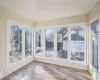 Unfurnished sunroom featuring a healthy amount of sunlight and lofted ceiling