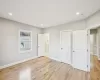 Primary bedroom with light hardwood / wood-style flooring and a healthy amount of sunlight