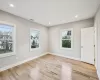 Bedroom with light wood-type flooring and multiple windows