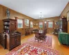 Dining room with wood walls, light hardwood / wood-style floors, and an inviting chandelier