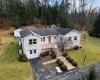 View of front of property featuring a front yard, an outbuilding, and a garage