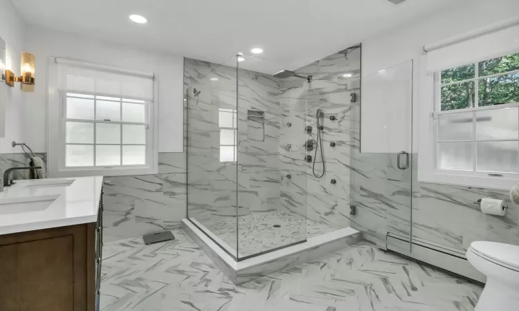 Bathroom featuring vanity, a baseboard radiator, an enclosed shower, and toilet