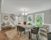 Dining area with wooden ceiling, an inviting chandelier, dark hardwood / wood-style flooring, a baseboard heating unit, and crown molding