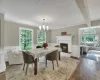 Dining room with a brick fireplace, plenty of natural light, dark wood-type flooring, and a baseboard heating unit