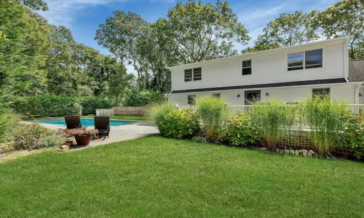 View of yard featuring a fenced in pool and a patio