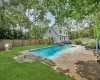 View of pool featuring a patio area and a yard